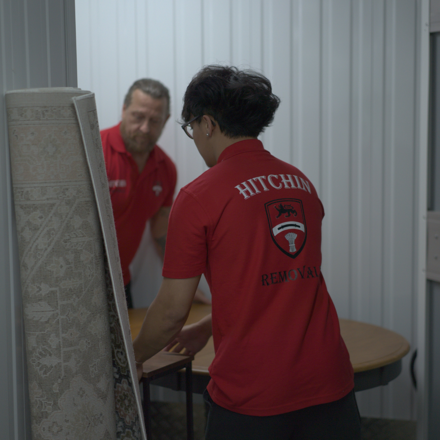 Hitchin Removals team organizing items in a storage unit